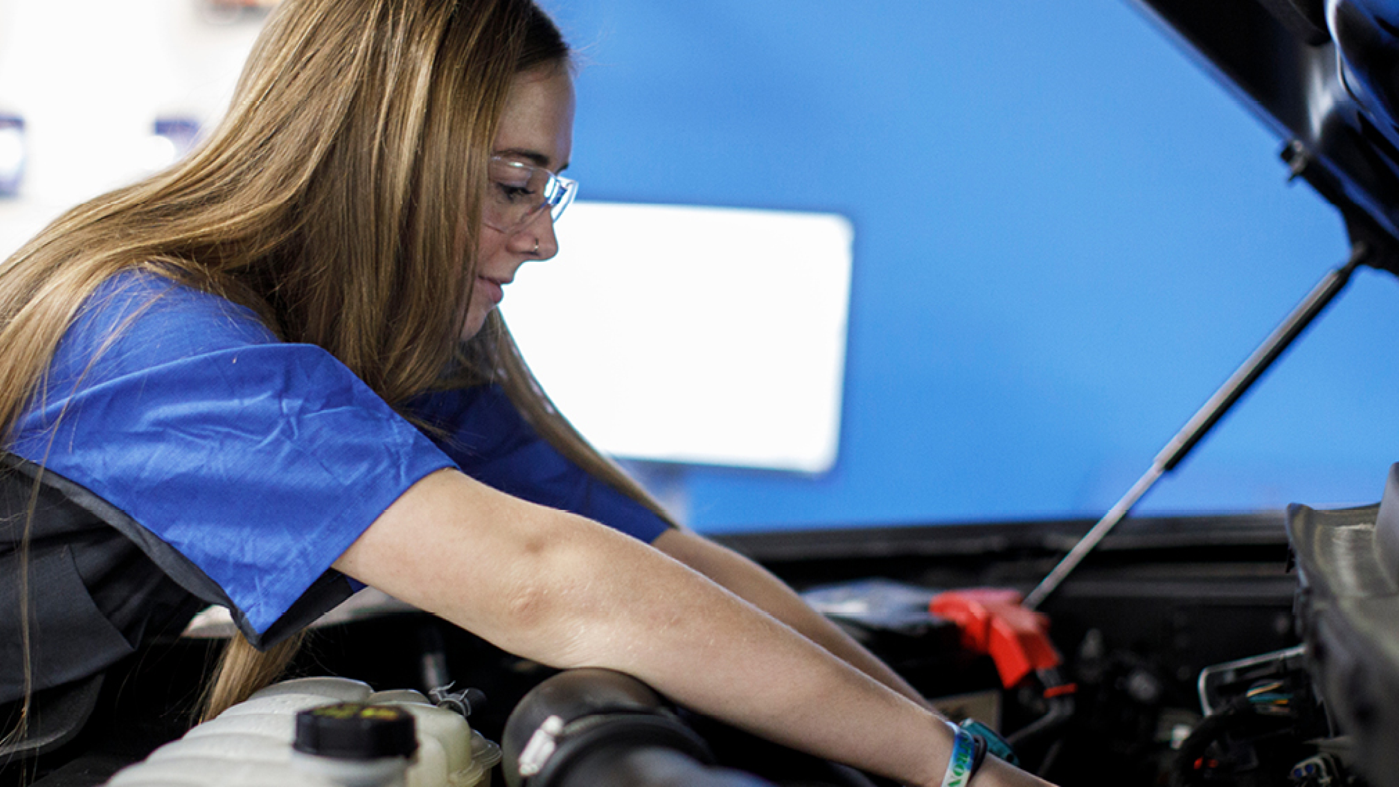 A girl working on a car